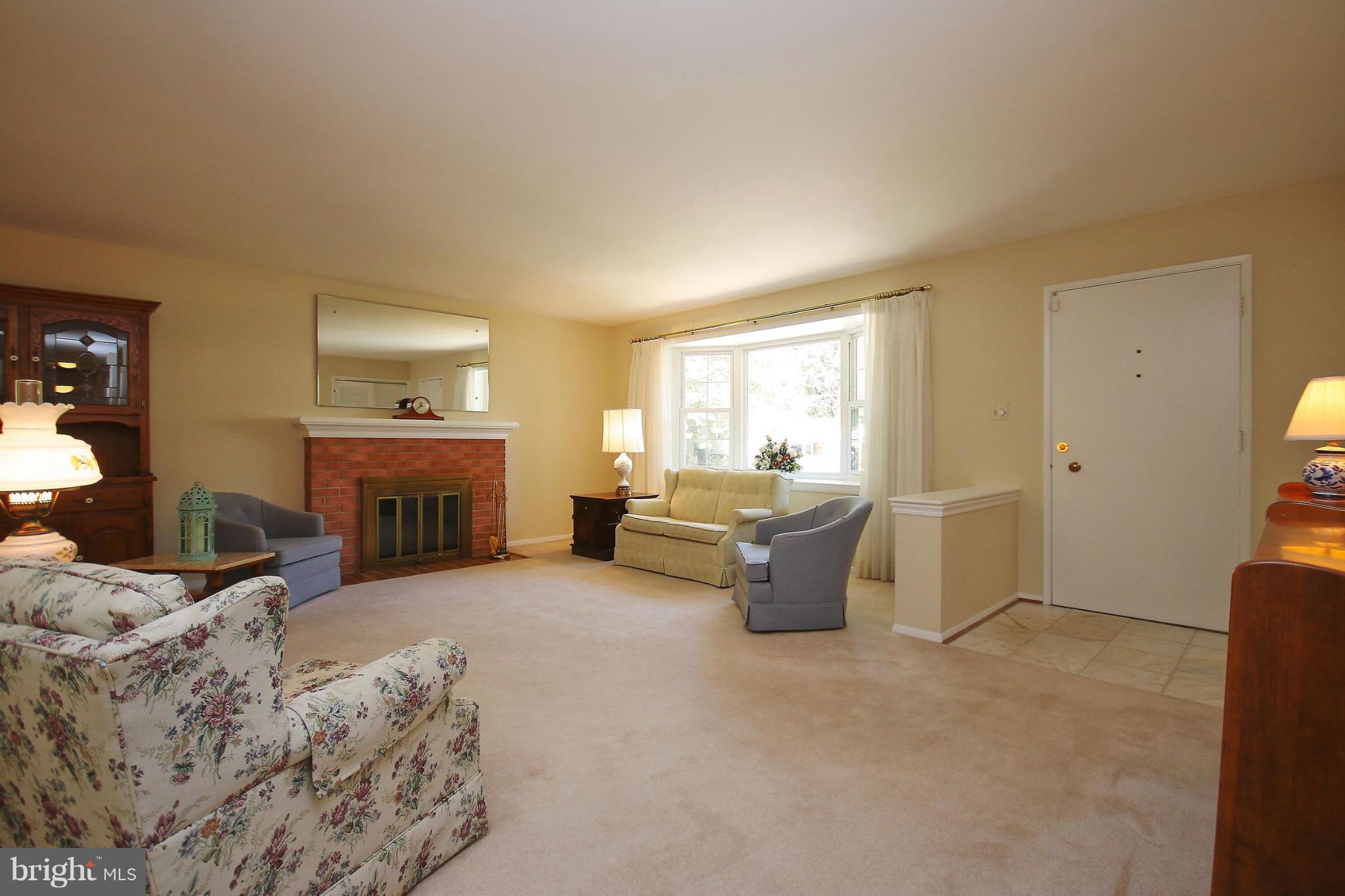 7927 Ellet Road Springfield, VA 22151 - Photo 4 of 30 a living room with furniture and a fireplace