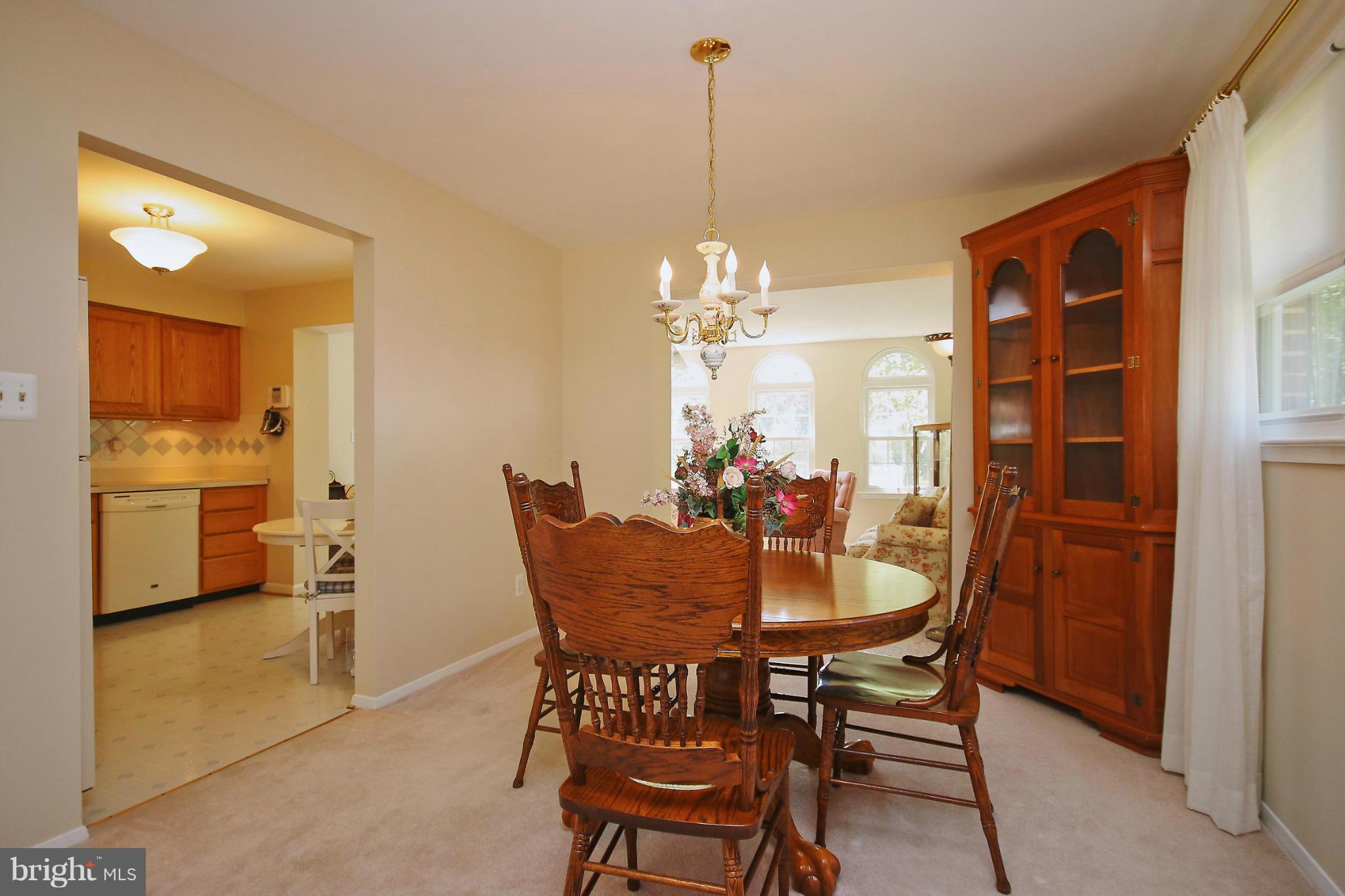 7927 Ellet Road Springfield, VA 22151 - Photo 7 of 30 a view of a dining room with furniture and a chandelier