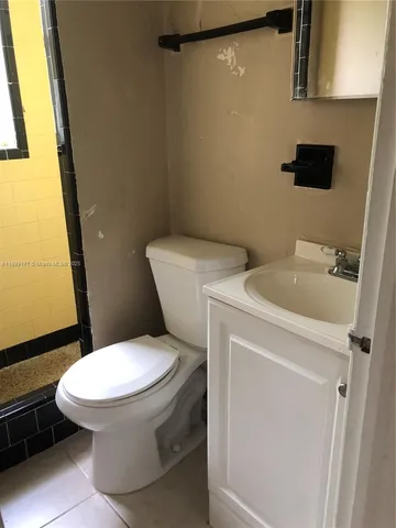 a white toilet sitting next to a bathroom sink