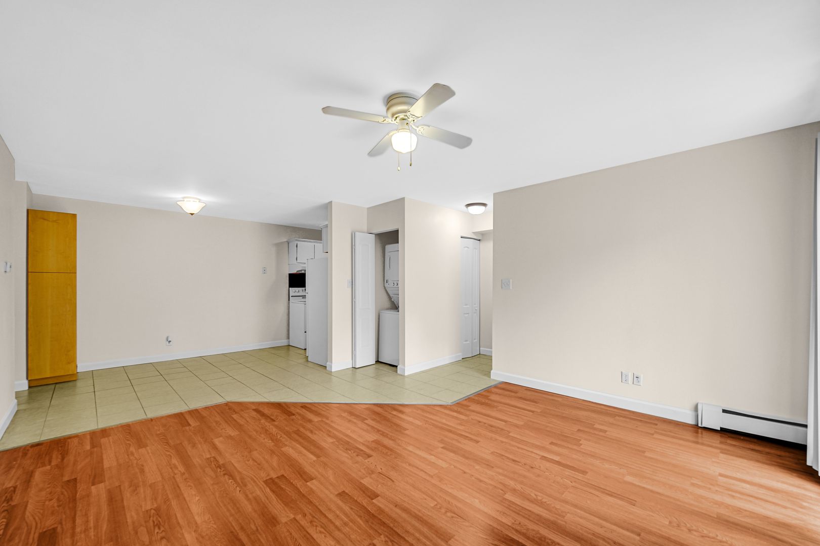 2600 Light Road, Unit 209 Oswego, IL 60543 - Photo 3 of 15 a view of empty room with wooden floor and fan