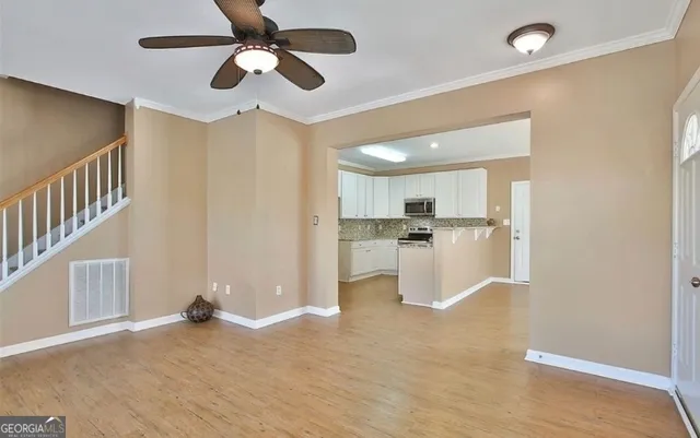 a view of kitchen with refrigerator and window
