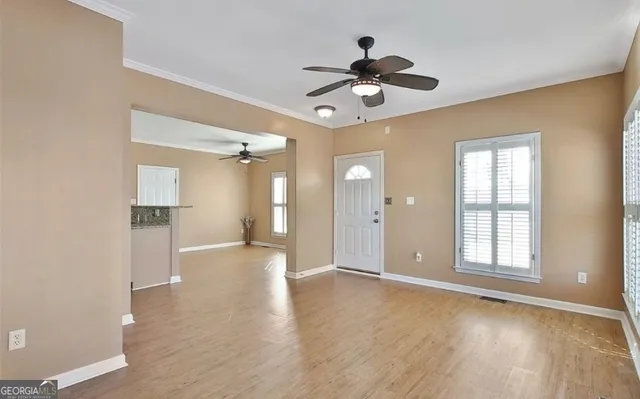 wooden floor in an empty room with a window