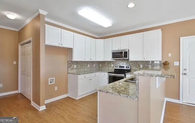 a kitchen with a refrigerator stove and microwave