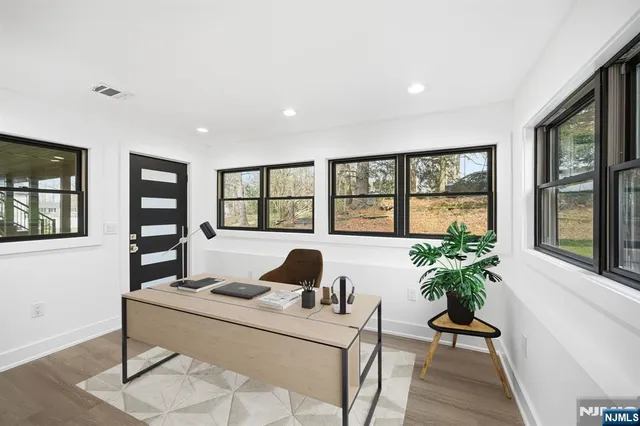 a living room with furniture and a potted plant