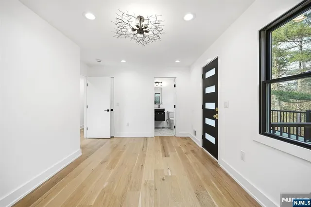 a view of a room with wooden floor and a window