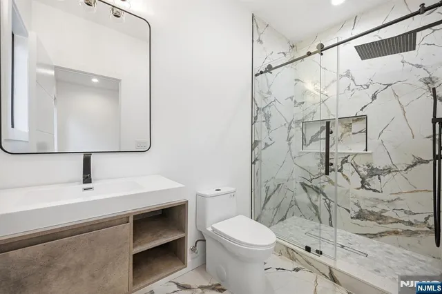 a bathroom with a toilet sink and shower