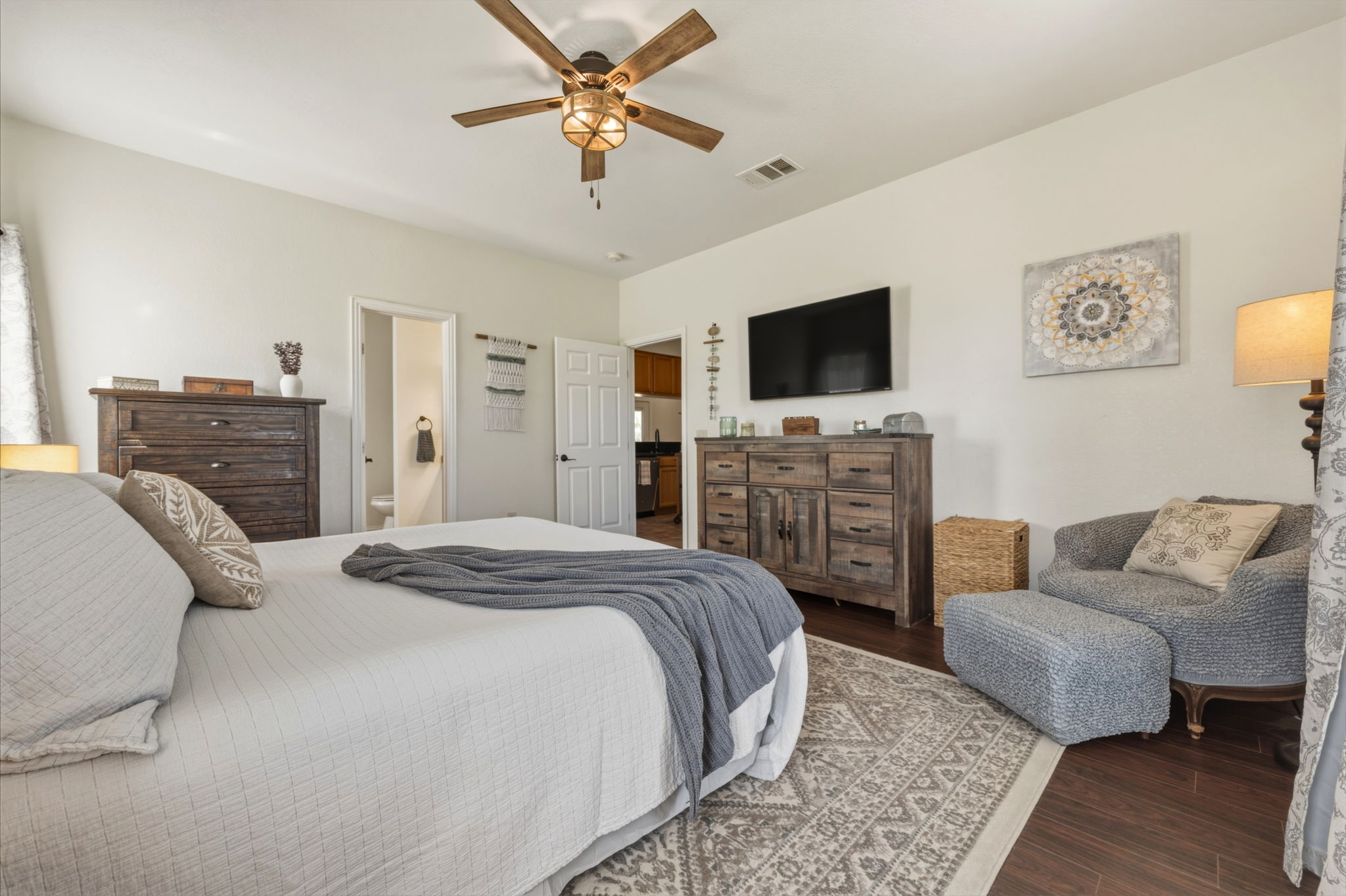 1516 Old Luling Road Lockhart, TX 78644 - Photo 12 of 39 Bedroom with wood-style floors, a ceiling fan, and ensuite bathroom