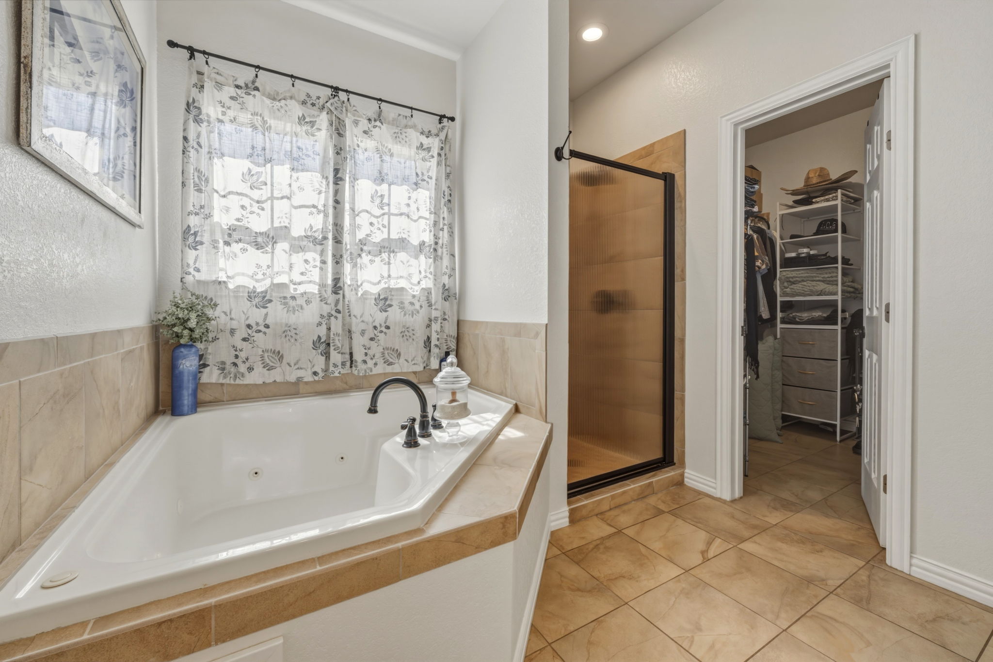 1516 Old Luling Road Lockhart, TX 78644 - Photo 14 of 39 Full bathroom featuring a shower stall, a jetted tub and walk in closet