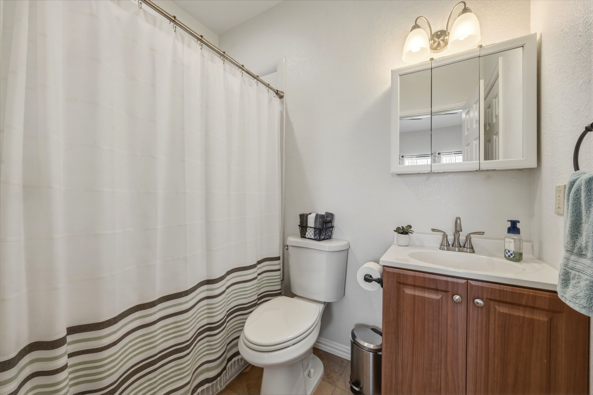 1516 Old Luling Road Lockhart, TX 78644 - Photo 16 of 39 Ensuite Bathroom featuring vanity and curtained shower plus a linen closet