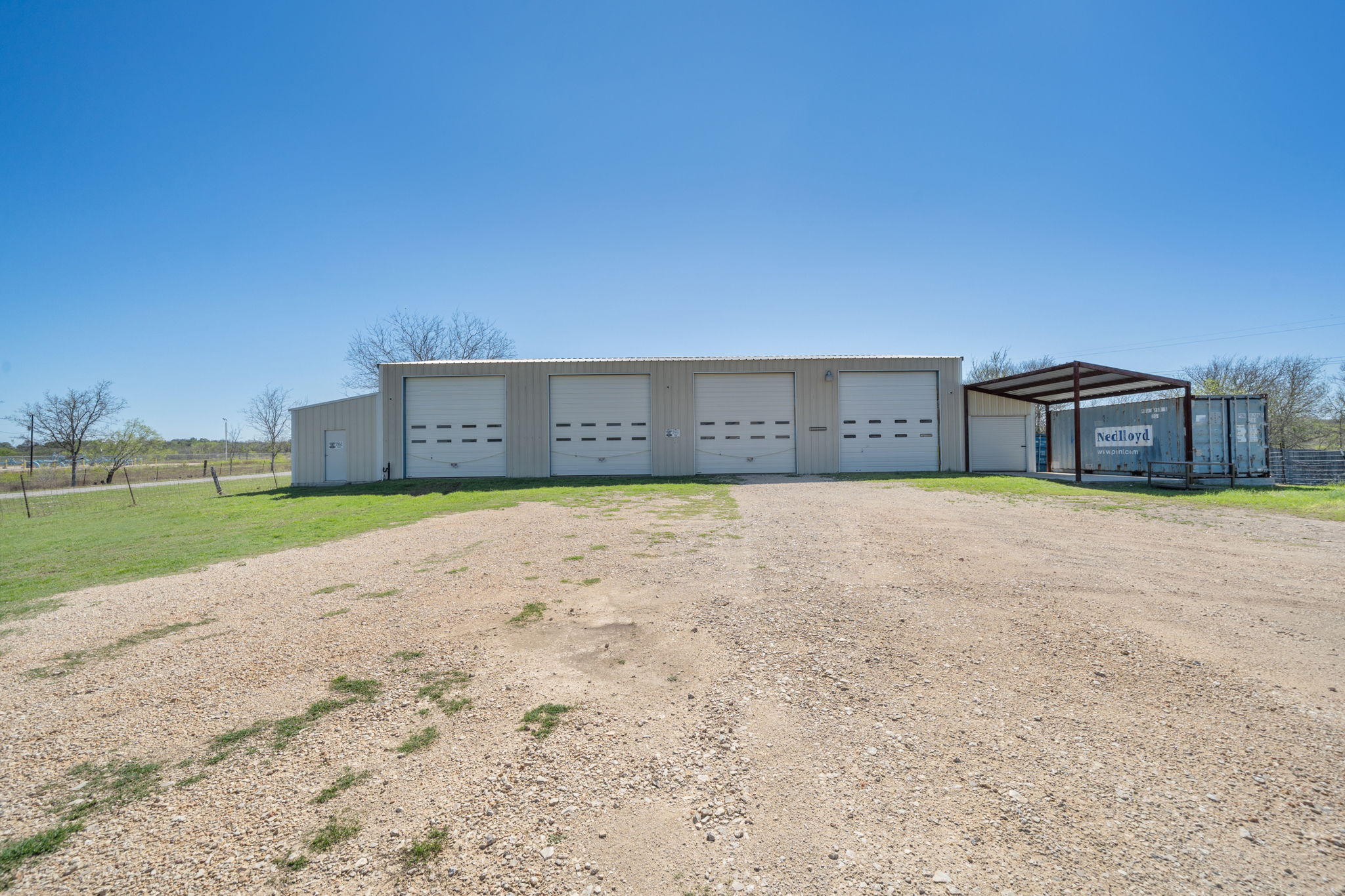1516 Old Luling Road Lockhart, TX 78644 - Photo 28 of 39 Detached 3440 Sq Ft Shop (4-20' Tall Roll up doors) with 400 Sq Ft Storage and 400 Sq Ft Office or Retail Space