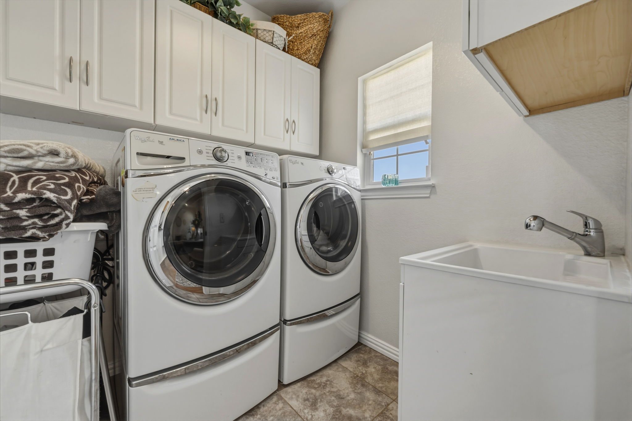 1516 Old Luling Road Lockhart, TX 78644 - Photo 10 of 39 Laundry room featuring separate washer /dryer, cabinet storage plus Utility sink