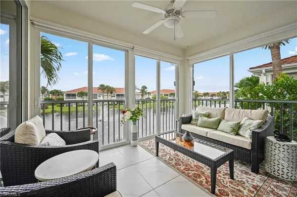 a living room with furniture and a floor to ceiling window