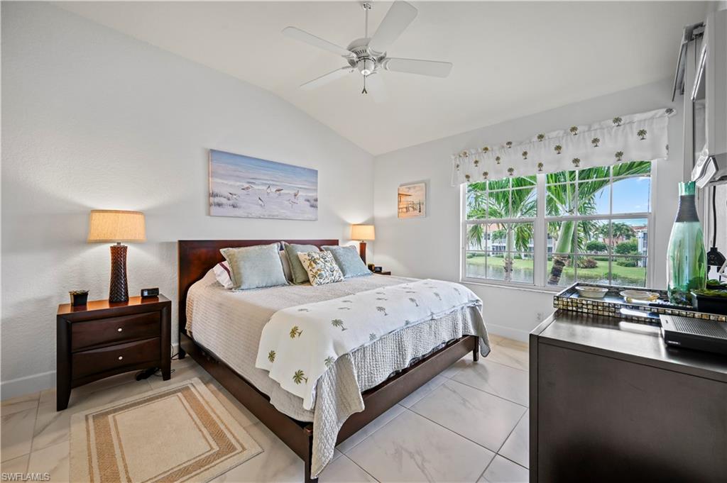 23741 Old Port Road, Unit 204 Estero, FL 34135 - Photo 13 of 46 a bedroom with a bed and a large window