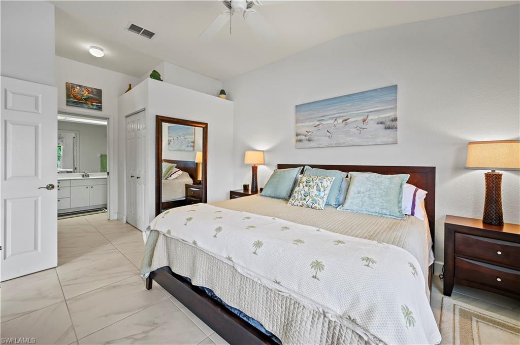 23741 Old Port Road, Unit 204 Estero, FL 34135 - Photo 14 of 46 a large white bed in a white room