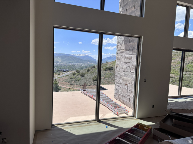 1918 Chimney Rock Road Heber City, UT 84032 - Photo 25 of 74 Expansive floor-to-ceiling sliding glass doors open to an outdoor patio with a mountain backdrop