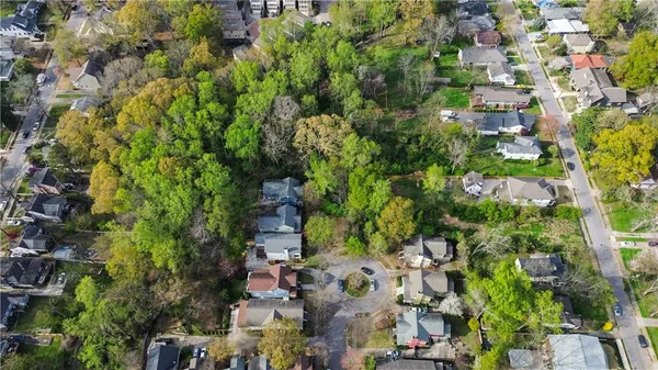 an aerial view of residential houses with tree