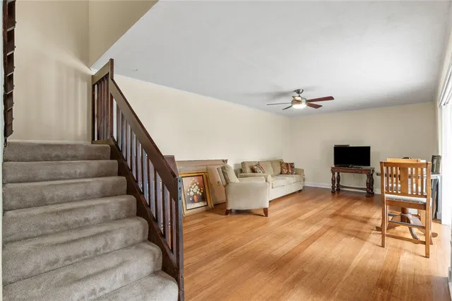 a view of entryway livingroom and hall with wooden floor