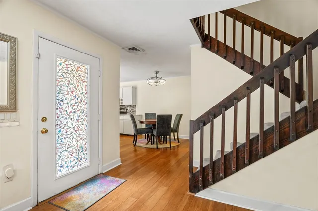 a view of entryway with wooden floor and stairs
