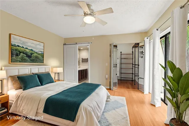 a bedroom with a large bed and a chandelier