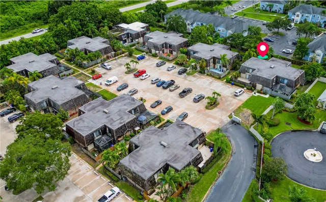 an aerial view of multiple houses with yard