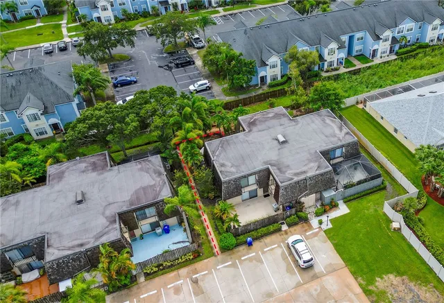 an aerial view of a house with garden space and street view