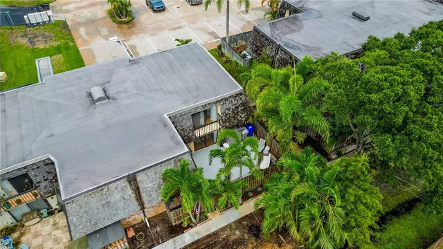 an aerial view of small house with yard