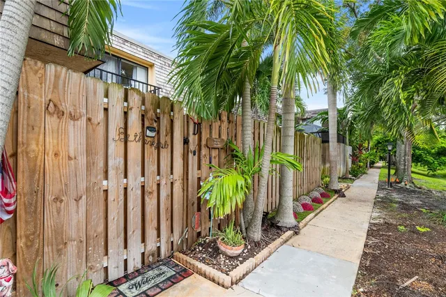 a view of a backyard with wooden fence