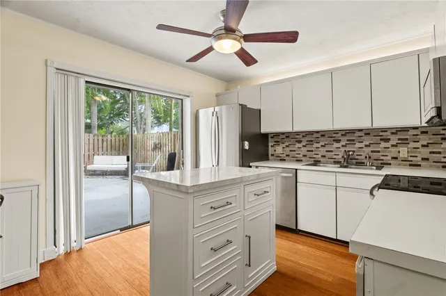 a kitchen with stainless steel appliances granite countertop a stove a sink and a refrigerator