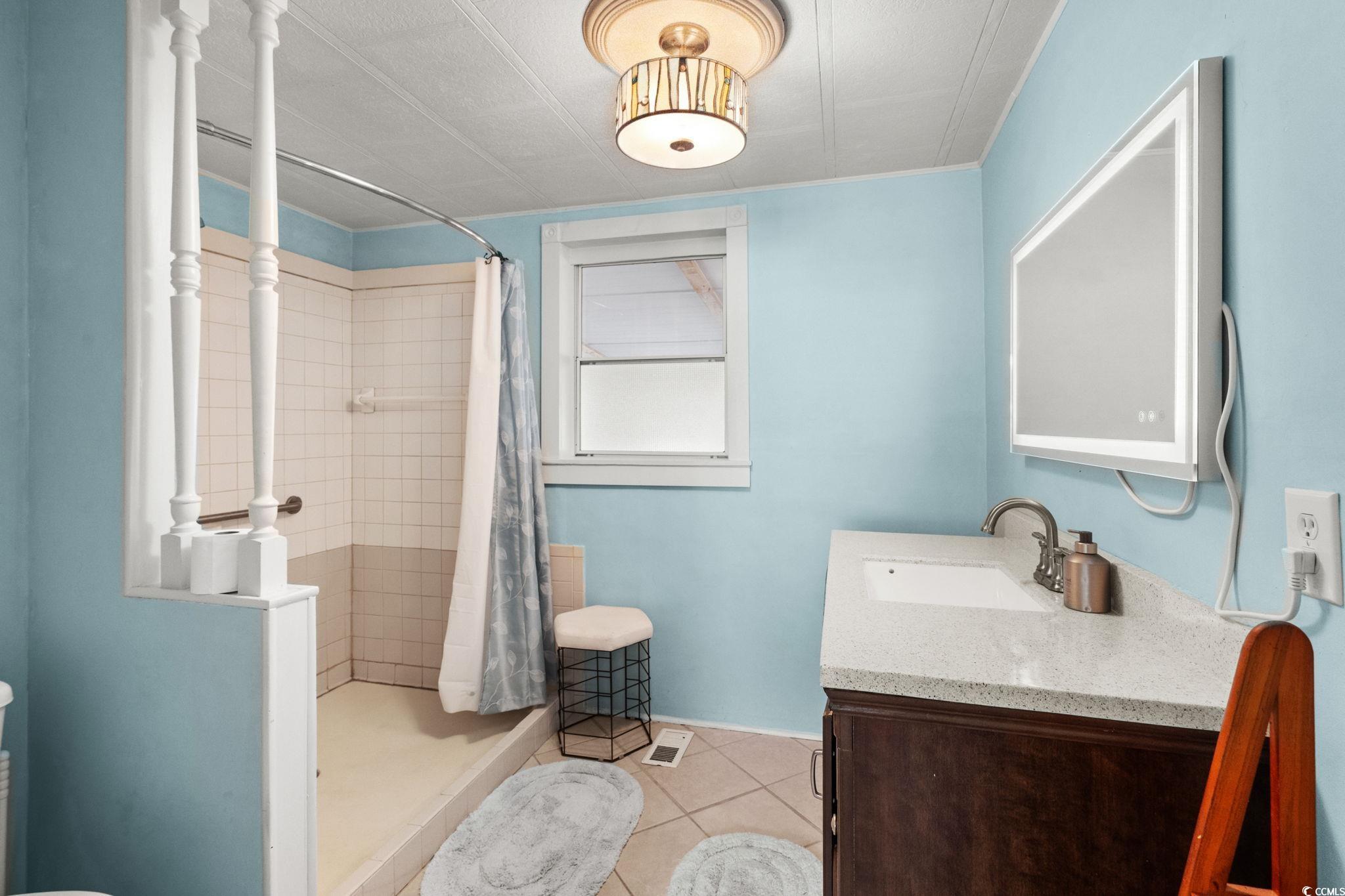 125 Moultrie Court Murrells Inlet, SC 29576 - Photo 19 of 40 Full bath featuring tile patterned flooring, vanity, and a stall shower