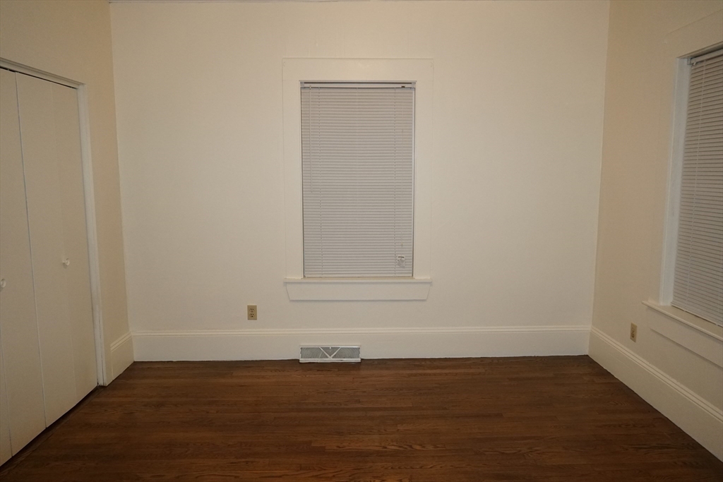 39 Burt Street, Unit 1 Berkley, MA 02779 - Photo 11 of 19 a view of an empty room with wooden floor and a window