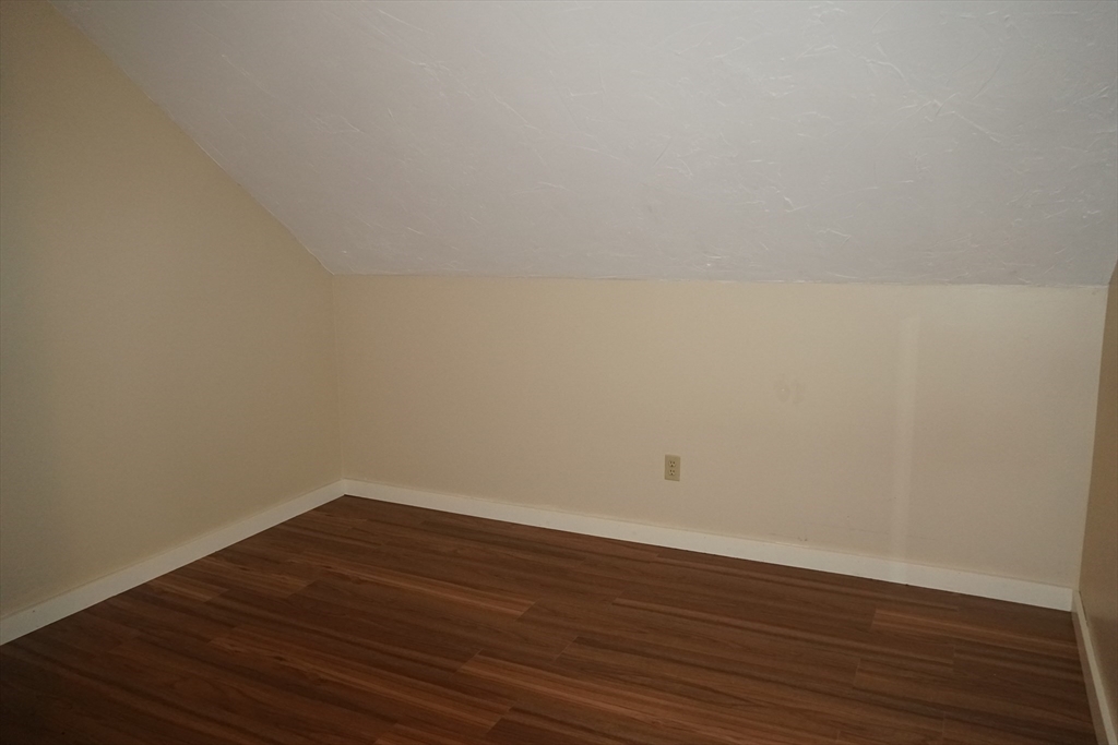 39 Burt Street, Unit 1 Berkley, MA 02779 - Photo 12 of 19 a view of an empty room with wooden floor
