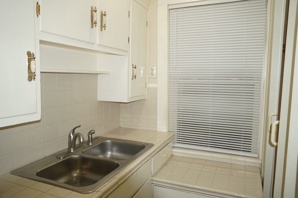 39 Burt Street, Unit 1 Berkley, MA 02779 - Photo 6 of 19 a kitchen with a sink and cabinets