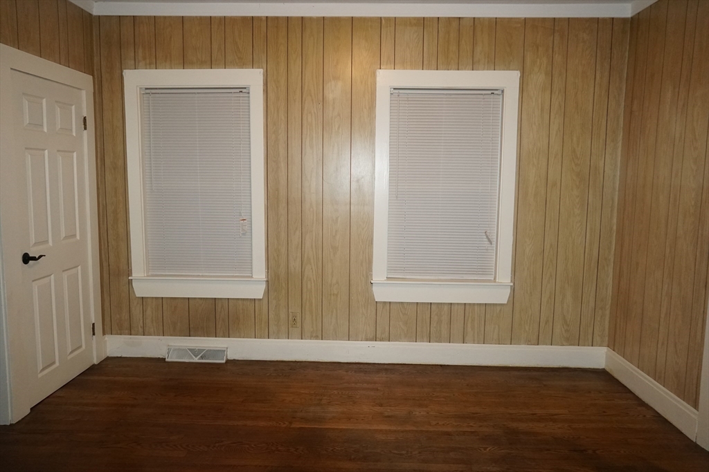 39 Burt Street, Unit 1 Berkley, MA 02779 - Photo 8 of 19 an empty room with wooden floor and windows