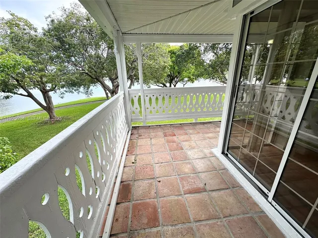 a view of a balcony with wooden floor and outdoor space