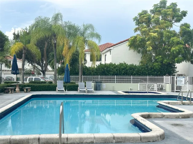 a view of a swimming pool with a yard