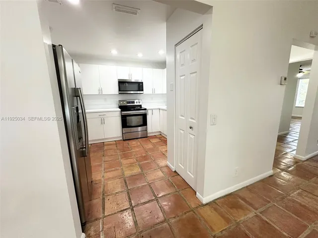 a kitchen with stainless steel appliances a refrigerator and a stove top oven