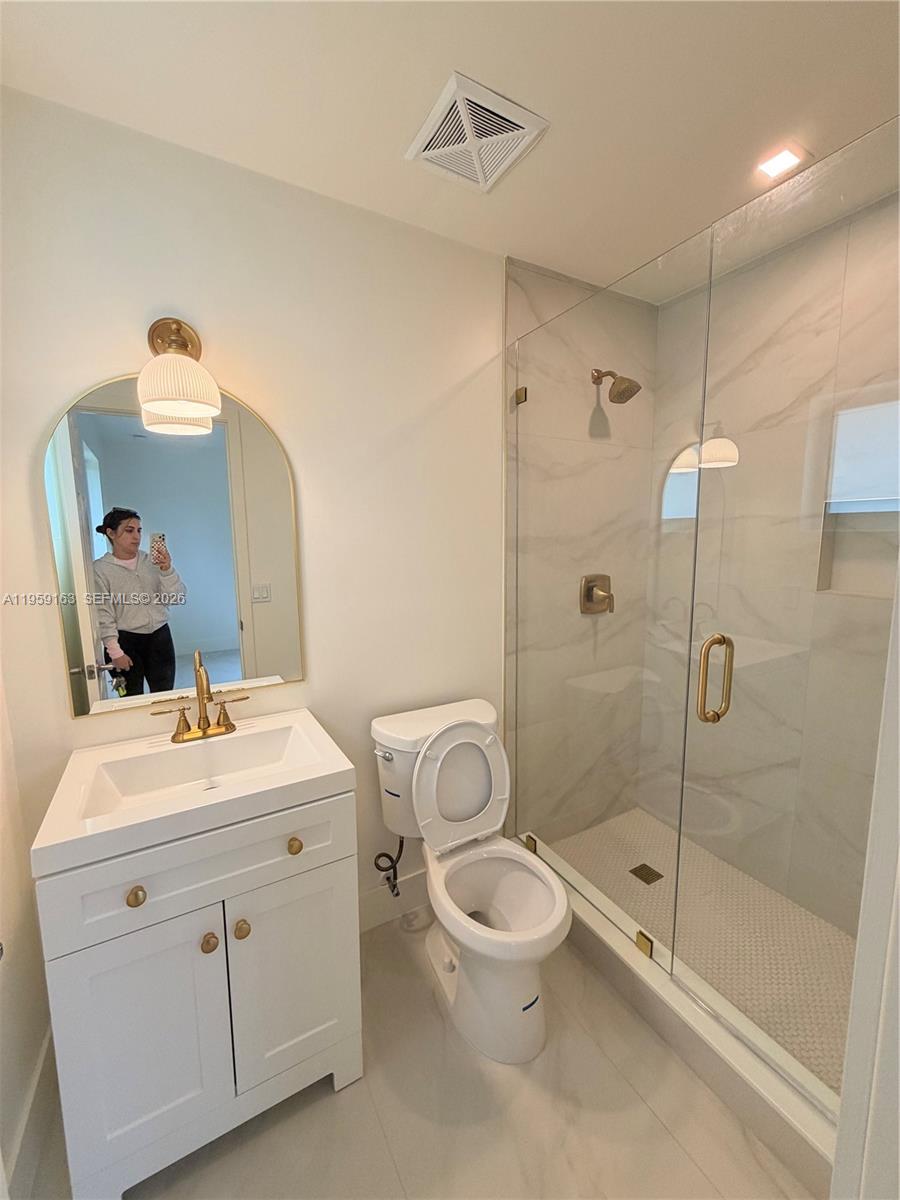 19221 Southwest 92nd Road Cutler Bay, FL 33157 - Photo 27 of 30 a bathroom with a sink a toilet and shower