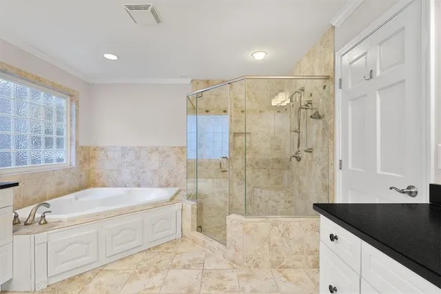 a spacious bathroom with a tub shower and sink