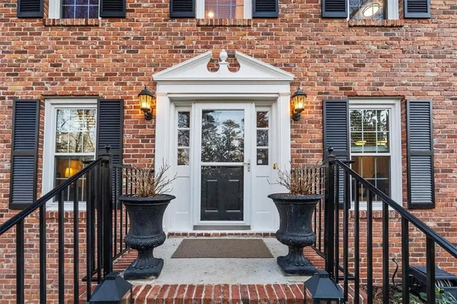 a view of a brick house with large windows
