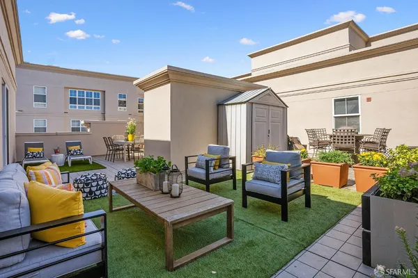 a living room with patio furniture and a potted plant