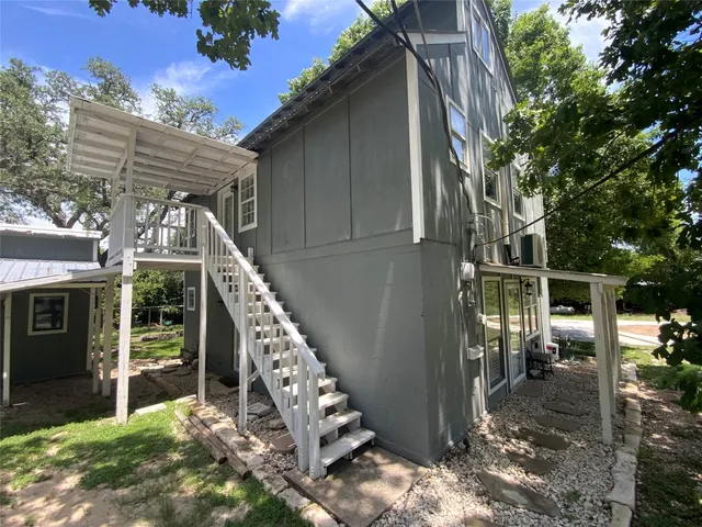 a view of a chair and table in the backyard