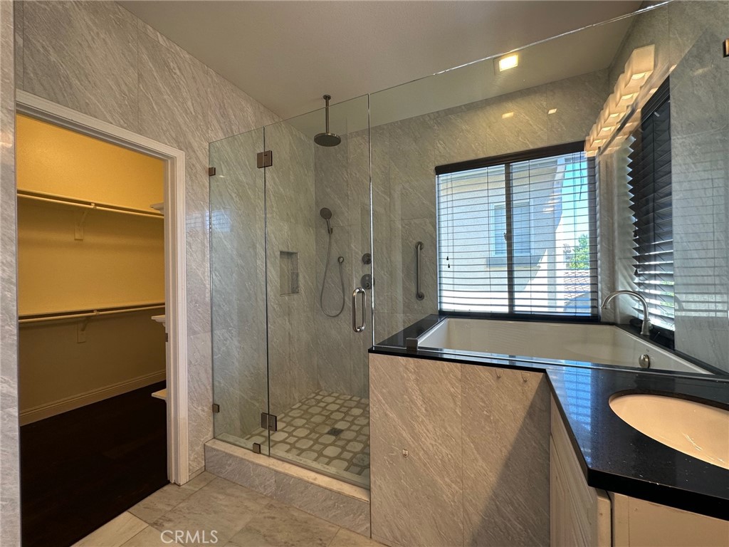 33 Sagebrush Irvine, CA 92618 - Photo 12 of 22 a spacious bathroom with a granite countertop sink and a shower