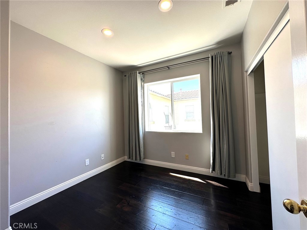 33 Sagebrush Irvine, CA 92618 - Photo 13 of 22 an empty room with wooden floor and windows with curtains