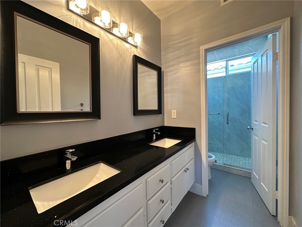 33 Sagebrush Irvine, CA 92618 - Photo 16 of 22 a bathroom with double vanity and a mirror