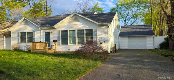a front view of a house with a garden and yard