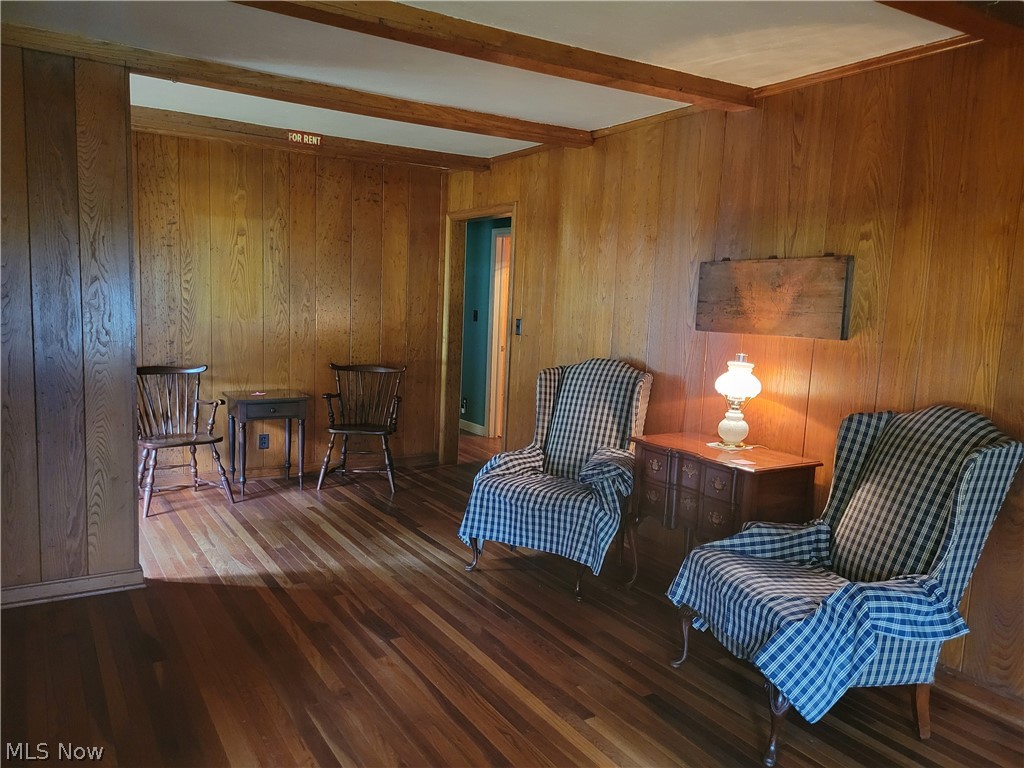 7357 Westview Road Kent, OH 44240 - Photo 9 of 30 Sitting room featuring beam ceiling, wood-type flooring, and wood walls