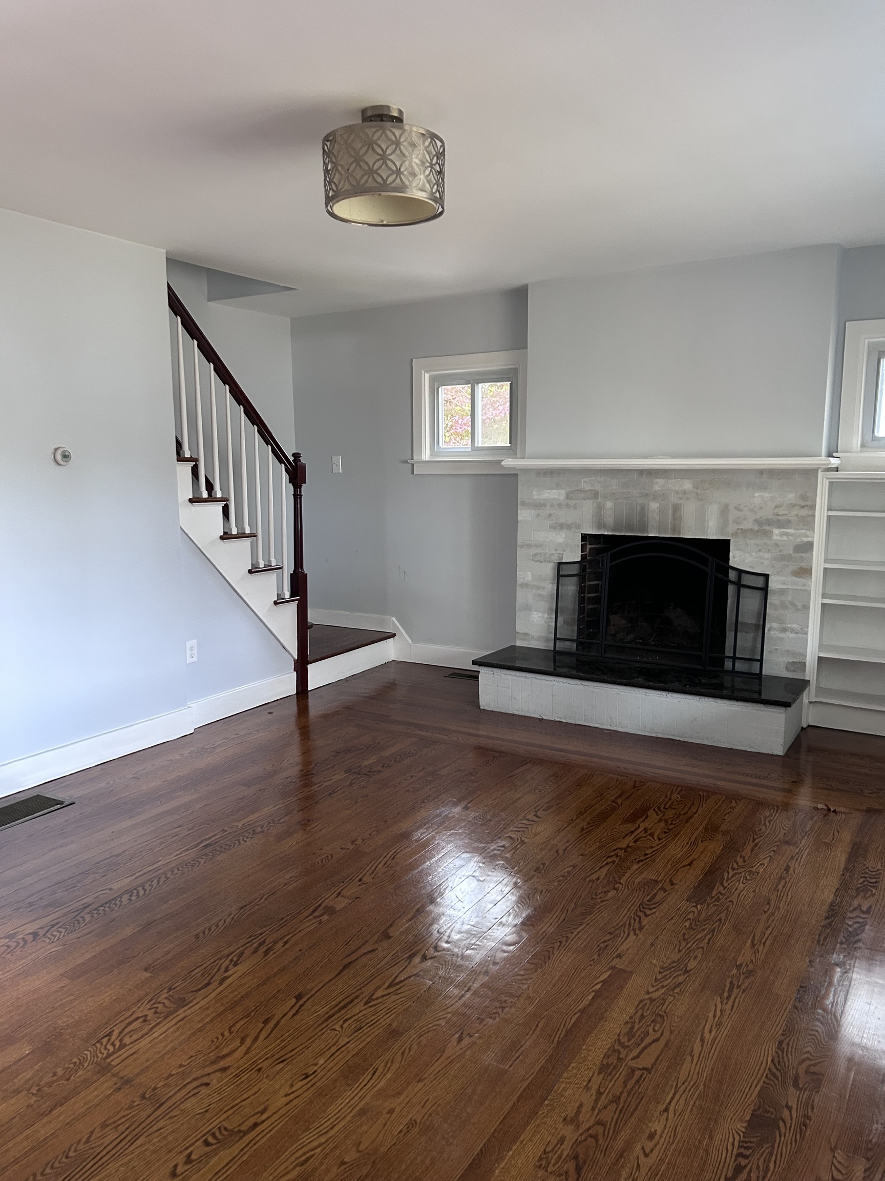 36 Forest Hills Road West Haven, CT 06516 - Photo 13 of 22 a view of an empty room with wooden floor fireplace and a window