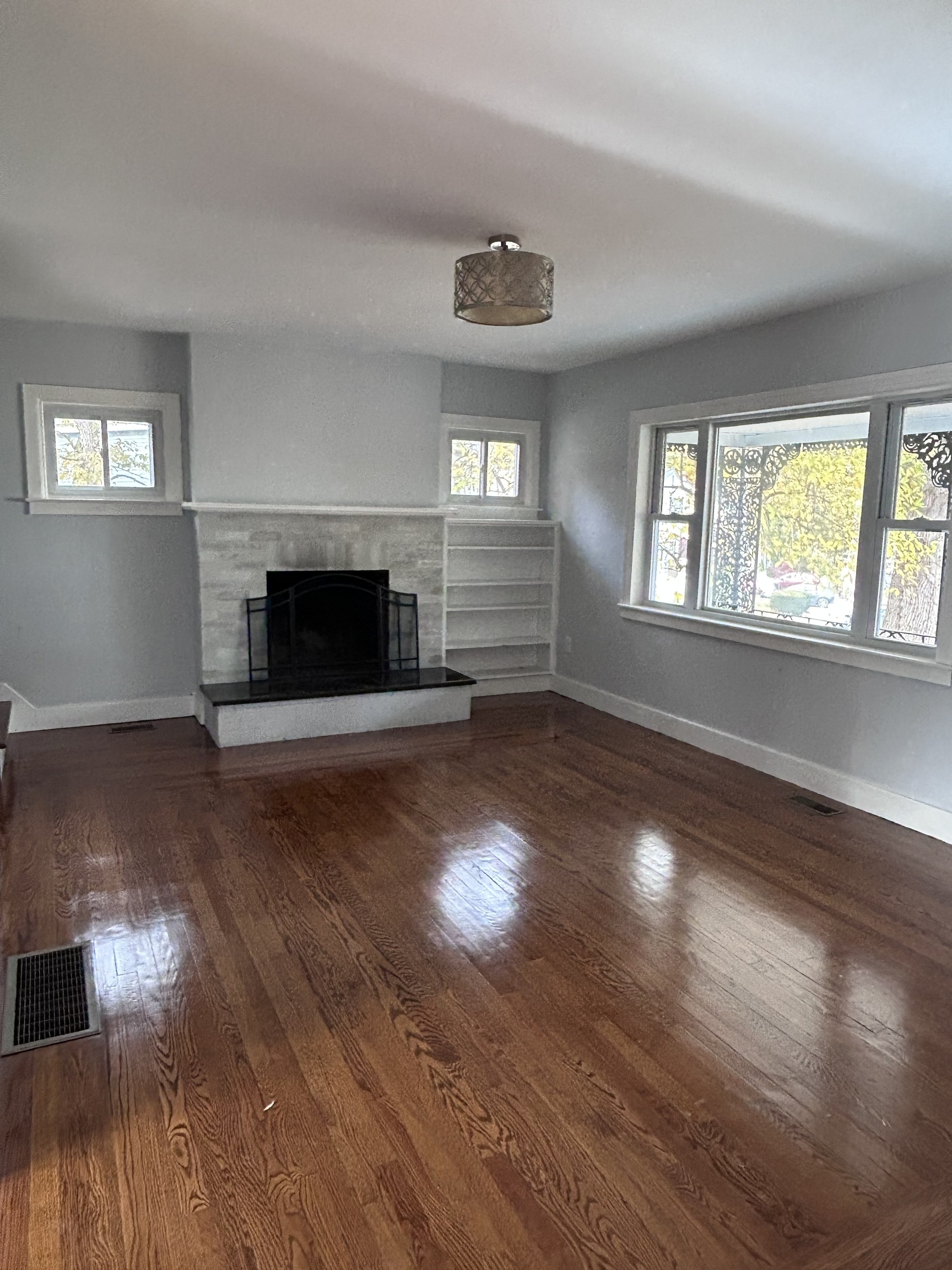 36 Forest Hills Road West Haven, CT 06516 - Photo 4 of 22 an empty room with wooden floor fireplace and windows