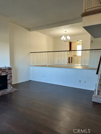 a view of water heater room with wooden floor