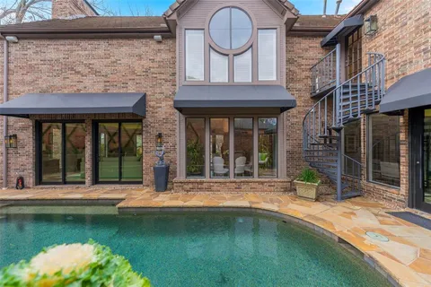 a swimming pool with outdoor seating and yard